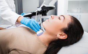 woman getting ultrasound of thyroid