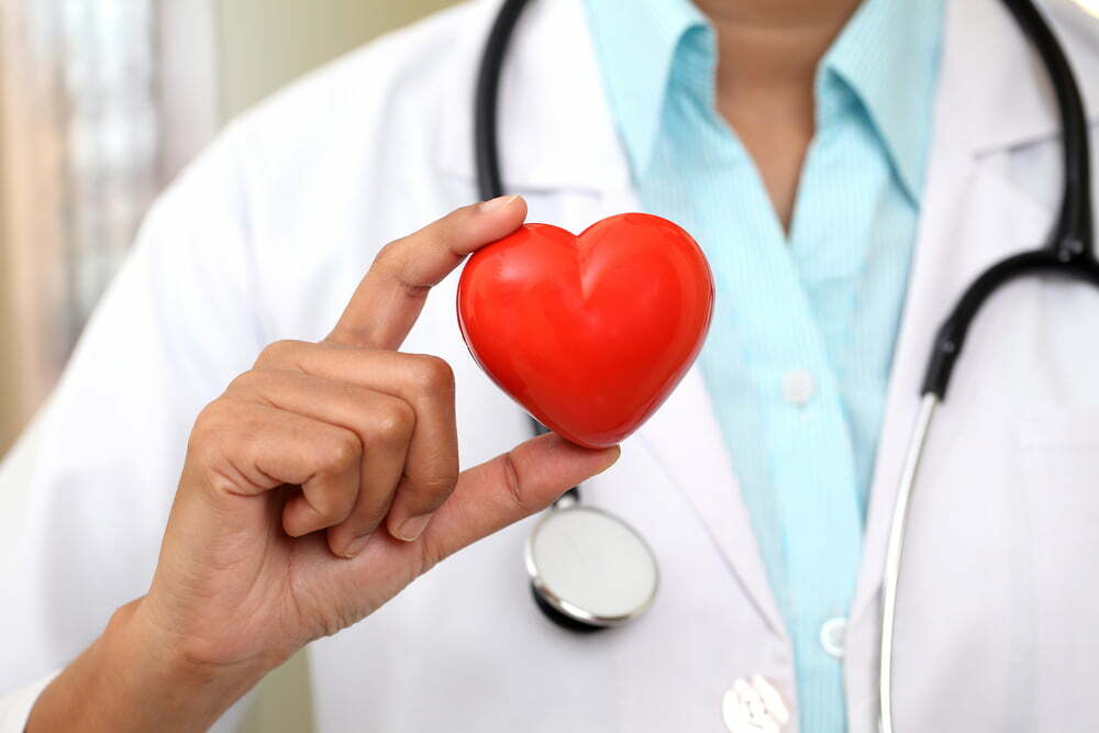 doctor holding a red love heart