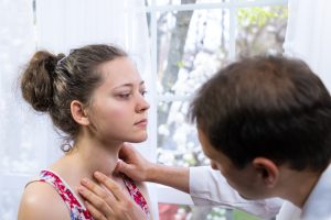 doctor examining patient